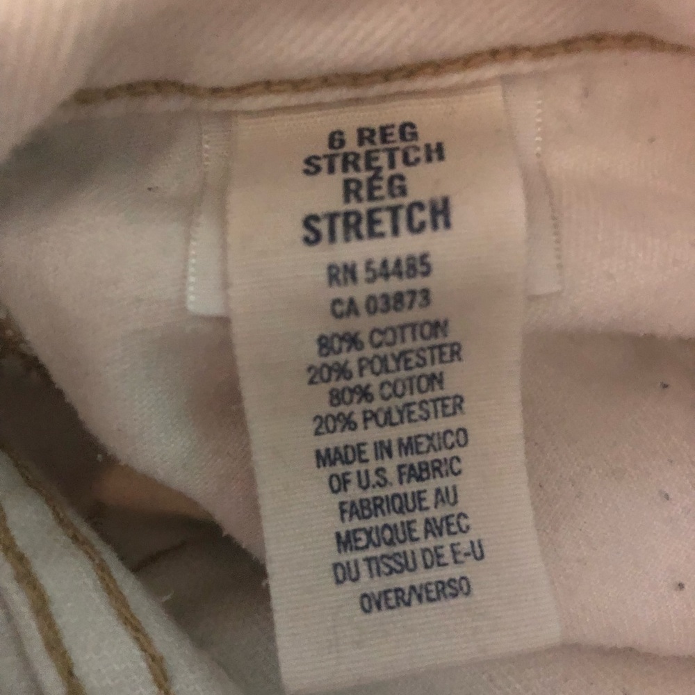 Vintage white with tan seeming low waisted boot cut American Eagle Jeans